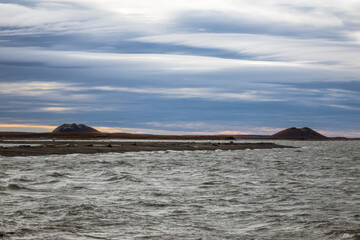 Arctic Ocean from Tuktoyaktuk with Pingo rock formations 