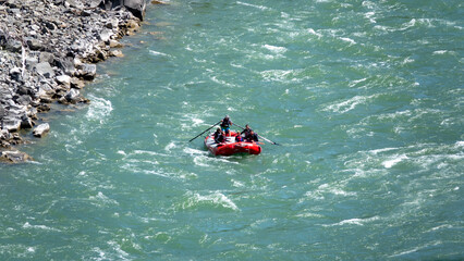Group of tourists having fun doing rafting on a river