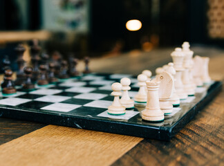 A chess set on a bar top table.