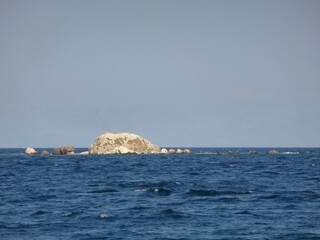 A rocky cliff in the midst of raging sea waves