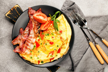 Omelet with vegetables and bacon.