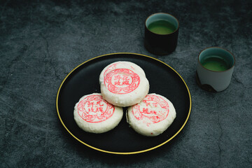 Delicious Chinese traditional cake, rose and flower cake. Delicious Chinese sweet rose cake. Translation of Red Chinese Characters on Dim Sum: Rose Cake.