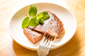 A fine steak dinner on a wood-grain table