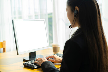 Call center concept. Asian business women are talking to their customers online, using computers to help with work