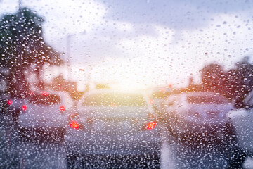 Driving in rain. Blurred background. Street in the heavy rain. Water drops or rain in front of mirror of car on road or street.