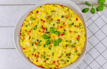 Delicious breakfast omelet or scrambled eggs with red and green bell peppers.