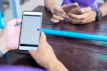 Search concept. Asian businessman is using a smartphone. Use your finger to touch the screen to search