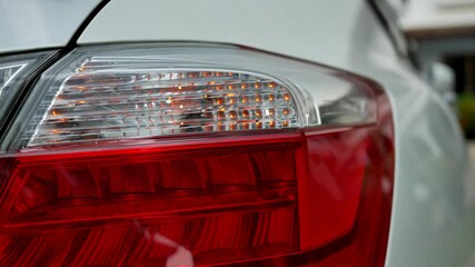 closeup of rear lamp signal for turn of car.