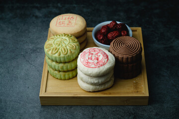 Delicious traditional Chinese pastry on a dark background. Yellow dim sum Chinese...