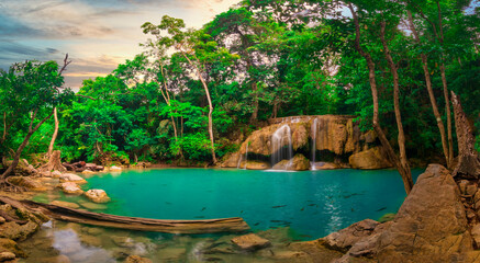 Panorama photo of  erawan waterfall in the tropical jungle surrounded by a natural with turquoise clear fresh water and green forest on mountain in kanchanaburi, thailand.