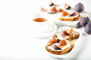 Bruschetta with figs, ricotta (cream cheese),  honey. Healthy food concept.  Top view.