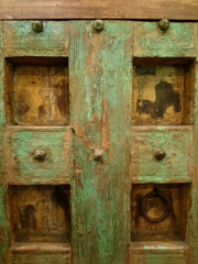 Vintage rustic looking wooden green door with artistic details