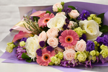 bouquet of colorful flowers in a flower shop in the packaging lies background.