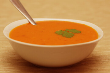 Pumpkin soup in white bowl