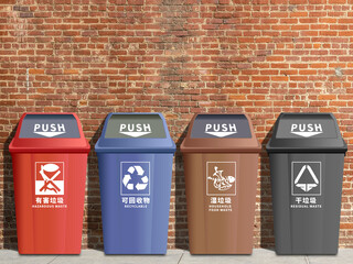 Recycling bins sorted by colour under brick walls