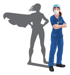 A nurse or doctor super hero woman in surgical or hospital scrubs with stethoscope and mask PPE. With arms folded and serious but caring look. Revealed as a superhero by the shape of her shadow. © Christos Georghiou