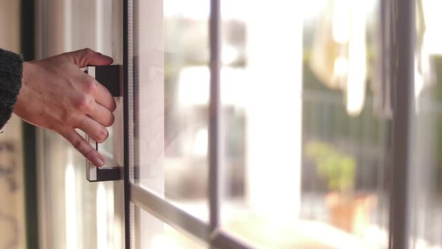 young man opening balcony sliding window door slow motion