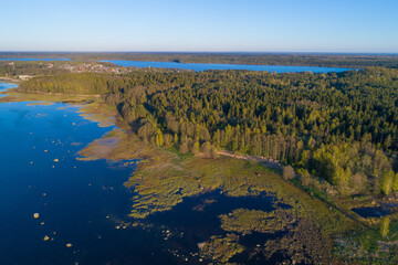 Over the southern coast of the Finnish Bay on a May evening (aerial photography). The surroundings of the village of Shepelevo. Leningrad region, Russia