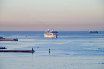 Small white Oceania Cruises cruiseship or cruise ship liner Regatta arrival into port during early...