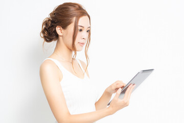 タブレット端末を使う若い女性