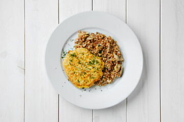 Top view of chicken cutlet with buckwheat and mushrooms