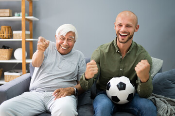 Grandpa And Grandson Watching Football