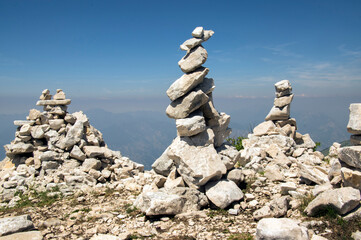 View point with white stone cairns on hiking trail Alta Via del Monte Baldo, ridge way in Garda Mountains