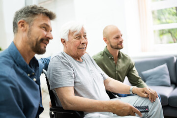 Family Watching TV In Living Room