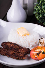 beef kebab with buttered rice, grilled tomato and onion