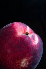 a ripe peach in dark background