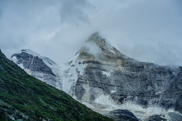 The snow mountains in Yading, Sichuan, China, summer time, on a cloudy day.