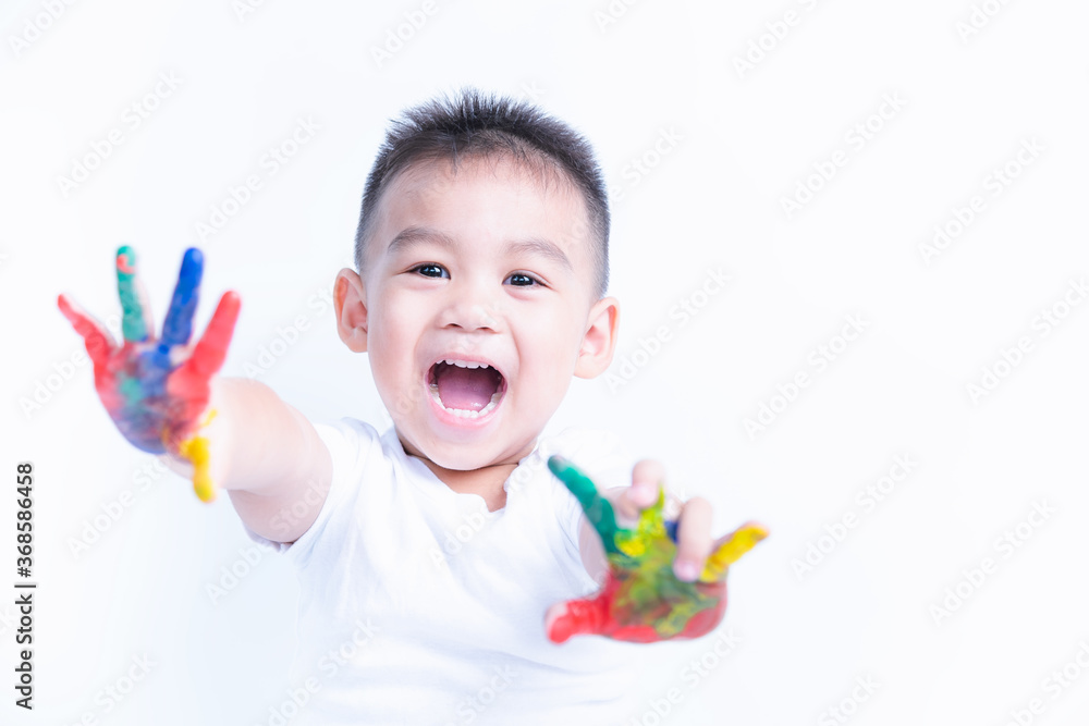 Wall mural portrait of asian happy little baby boy happy face show hand he has watercolor or finger paint on ha