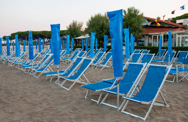 empty sun loungers on a private beach due to covid virus, pandemic