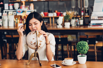 Lifestyle freelance woman he has travel planning to holiday after weekend work in a coffee cafe shop