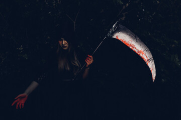 Woman devil ghost demon costume horror and scary she holding scythe or reaper on hand, Happy Halloween day concept