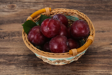 Plum heap in the wooden basket