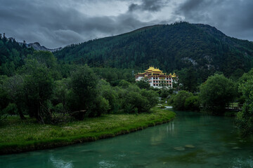 Fototapeta na wymiar Chonggu Temple, a traditional Tibetan Temple in Yading, Sichuan, on a cloudy day, summer time.