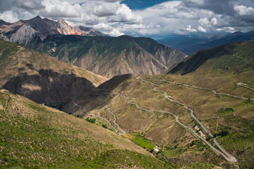 The road from Sichuan to Tibet, bends over on mountains, on a cloudy day.