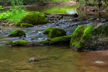 Naklejka na ściany i meble A small rocky river in spring Taken in Latvia, Raunis river
