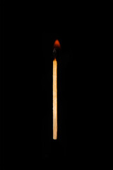 One burning match on a completely black background