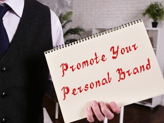 Conceptual photo about Promote Your Personal Brand with handwritten text.