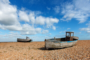 Two abandoned fishing boats on the shingle beach at Dungeness - the area has such low rainfall as...