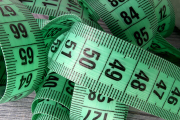 measuring tape on wooden background