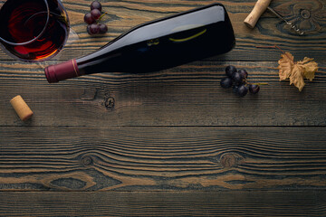 Bottle of red wine with label. Glass of wine and grape. Wine bottle mockup.
