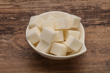 Refined white sugar cubs in the bowl