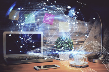 Computer on desktop with social network hologram. Double exposure. Concept of international people...