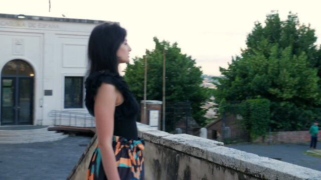 young sensual woman on the terrace of janiculum fountain looking up