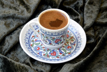 a cup of Turkish coffee on fabric background