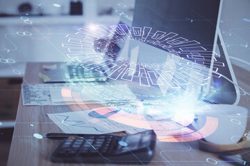 Double exposure of desktop computer and technology theme hologram. Concept of software development.