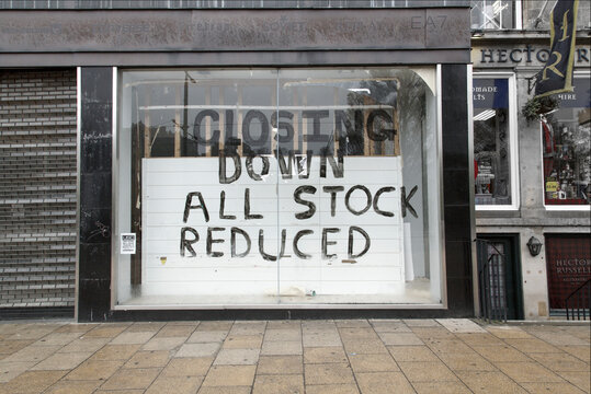 A shuttered shop with a 'closing down' sign written on the window. Many traders are going out of business because of the turn down in the economy.